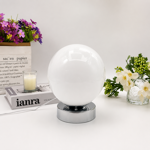 Globe table lamp, white blown-glass shade on a polished chrome base