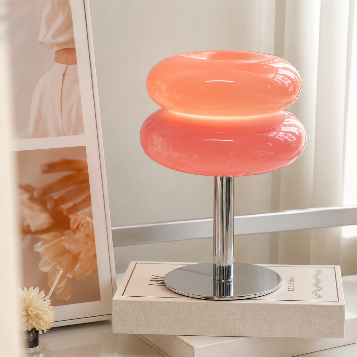 Pink Macaron lamp lit on a dressing table beside a mirror