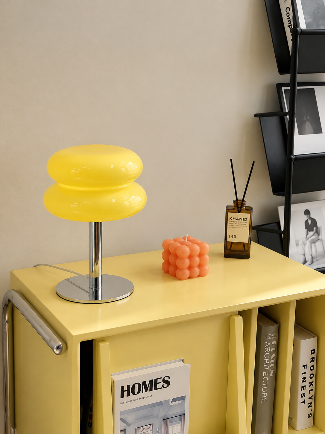Yellow Macaron lamp on a pale yellow cabinet in a styled home office